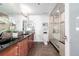 Modern bathroom with granite countertops, dual vanity, and glass-enclosed shower at 100 Park W Ave # 1606, Denver, CO 80205