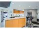 Modern kitchen with integrated appliances, sleek countertops, and barstool seating at 100 Park W Ave # 1606, Denver, CO 80205