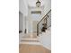 Bright and airy entryway featuring a staircase, hardwood floors, and a modern light fixture at 5272 W Capri Pl, Littleton, CO 80123