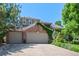 Charming two-story home boasts a lush lawn, mature trees, and an oversized attached garage at 5272 W Capri Pl, Littleton, CO 80123