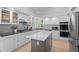 Beautiful kitchen with white cabinetry, modern appliances, and center island at 5272 W Capri Pl, Littleton, CO 80123
