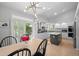 Eat-in kitchen with white cabinets, island, and stainless appliances at 5272 W Capri Pl, Littleton, CO 80123