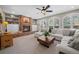 Cozy living room featuring a brick fireplace, built-in shelves, and ample seating for relaxation and entertainment at 5272 W Capri Pl, Littleton, CO 80123