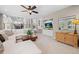 Living room features a modern ceiling fan and built-in entertainment center at 5272 W Capri Pl, Littleton, CO 80123