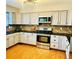 Well-equipped kitchen with stainless steel appliances, granite countertops, and light wood floors at 9686 W 106Th Ave, Broomfield, CO 80021