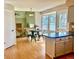 Bright breakfast nook with a round table, bar seating, and natural light from the windows at 9686 W 106Th Ave, Broomfield, CO 80021