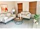 Cozy living room featuring neutral-toned furniture, a geometric coffee table, and natural light at 9686 W 106Th Ave, Broomfield, CO 80021