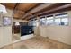 Bedroom with large windows, mirrored wall, and carpet at 5420 Manitou Rd, Littleton, CO 80123