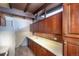 Mid-century kitchen with wood cabinets and brick backsplash at 5420 Manitou Rd, Littleton, CO 80123