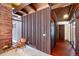 Living room with wood wall paneling and mid-century chair at 5420 Manitou Rd, Littleton, CO 80123