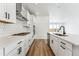 Modern kitchen with white cabinets, stainless steel appliances, and hardwood floors at 3361 N Buchanan Way, Aurora, CO 80019