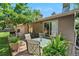 Inviting backyard deck with outdoor seating, potted plants and sliding glass door to the home at 6223 W Flora Pl, Denver, CO 80227