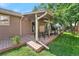 Covered backyard patio with a grill and outdoor seating, perfect for entertaining at 6223 W Flora Pl, Denver, CO 80227