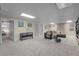 A finished basement with a large carpeted space and comfortable seating area at 6223 W Flora Pl, Denver, CO 80227