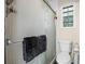 Bathroom showing frosted glass enclosed shower, toilet and small window at 6223 W Flora Pl, Denver, CO 80227