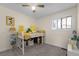 bedroom features a white bunk bed, window and neutral paint at 6223 W Flora Pl, Denver, CO 80227