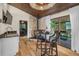 A breakfast nook features a decorative stone fireplace and views to a relaxing outdoor living space at 6223 W Flora Pl, Denver, CO 80227