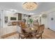 Dining area with chandelier open to living room and fireplace at 6223 W Flora Pl, Denver, CO 80227