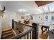 Bright foyer with wood flooring, a staircase, and an open view of the dining area at 6223 W Flora Pl, Denver, CO 80227