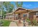 Charming front porch with brick accents, seating, and meticulous landscaping at 6223 W Flora Pl, Denver, CO 80227