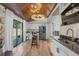 Updated kitchen with stainless appliances, wood floors, and breakfast nook at 6223 W Flora Pl, Denver, CO 80227