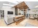 Open-concept living area with skylights, a fireplace, and stylish decor at 6223 W Flora Pl, Denver, CO 80227