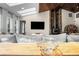 Bright living room featuring a stone fireplace and skylights at 6223 W Flora Pl, Denver, CO 80227
