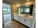 Bathroom featuring dual sinks and a large mirror at 13358 Blue Amber Ct, Parker, CO 80134