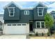Two-story home featuring a modern exterior, two-car garage, and well-maintained landscaping at 13358 Blue Amber Ct, Parker, CO 80134