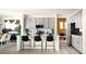 Modern kitchen featuring a central island with bar seating, sleek countertops, and contemporary appliances at 13358 Blue Amber Ct, Parker, CO 80134