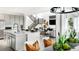 Open-concept kitchen seamlessly flows into the living area with an island, pendant lighting, and modern finishes at 13358 Blue Amber Ct, Parker, CO 80134