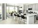 Modern kitchen with white countertops, gray cabinets, stainless steel appliances, and dining area with natural light at 13358 Blue Amber Ct, Parker, CO 80134
