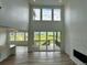 Open-concept living room showcasing an open floor plan, kitchen island, and abundant natural light at 13358 Blue Amber Ct, Parker, CO 80134