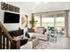Bright living room featuring a fireplace, entertainment center and sliding glass doors at 13358 Blue Amber Ct, Parker, CO 80134