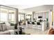 Open living room and kitchen area with bar seating and access to the outdoor deck at 13358 Blue Amber Ct, Parker, CO 80134