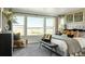 Spacious main bedroom featuring large windows, a cozy seating area, and a comfortable bed at 13358 Blue Amber Ct, Parker, CO 80134