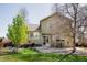 Charming backyard featuring a patio, lush lawn, and mature trees, offering a serene outdoor space at 1427 Deerwood Dr, Longmont, CO 80504
