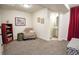 Finished basement area with comfortable seating, shelving, and adjacent bathroom, creating a relaxing retreat at 1427 Deerwood Dr, Longmont, CO 80504