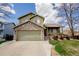 Charming two-story home with stone accents, attached garage, and inviting front porch at 1427 Deerwood Dr, Longmont, CO 80504