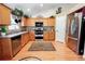 Spacious kitchen featuring stainless steel appliances, ample counter space and hardwood floors at 1427 Deerwood Dr, Longmont, CO 80504