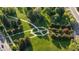 An aerial view of a park with walking paths and mature trees surrounded by lush greenery and open spaces at 2790 W 25Th Ave # 6, Denver, CO 80211