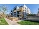 Modern townhome exterior with wooden accents, fenced yard and landscaping at 2790 W 25Th Ave # 6, Denver, CO 80211