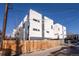 Modern two-story home with gray and white exterior and a wooden fence at 2790 W 25Th Ave # 6, Denver, CO 80211