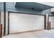 Attached two-car garage with white doors and concrete flooring at 2790 W 25Th Ave # 6, Denver, CO 80211