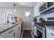 Well-equipped kitchen featuring stainless steel appliances, white subway tile backsplash, and modern fixtures at 2790 W 25Th Ave # 6, Denver, CO 80211