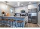 Bright, modern kitchen featuring stainless steel appliances, white cabinetry, and a sleek breakfast bar with stools at 2790 W 25Th Ave # 6, Denver, CO 80211