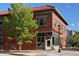 Charming brick building featuring a pizza restaurant with large windows and a sidewalk with street lights at 2790 W 25Th Ave # 6, Denver, CO 80211