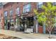 Exterior shot of a coffee shop with a bench, sidewalk, and tree-lined street in a walkable neighborhood at 2790 W 25Th Ave # 6, Denver, CO 80211