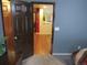 Hallway with a view through a doorway to a living area with wood floors at 559 Alton Way # C, Denver, CO 80230