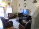 Open living room with leather furniture set, entertainment center, and lots of natural light at 559 Alton Way # C, Denver, CO 80230